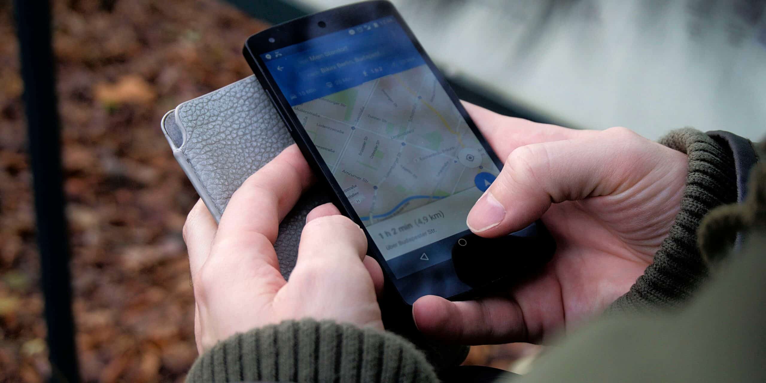 Person holding phone using Google Maps to find local location