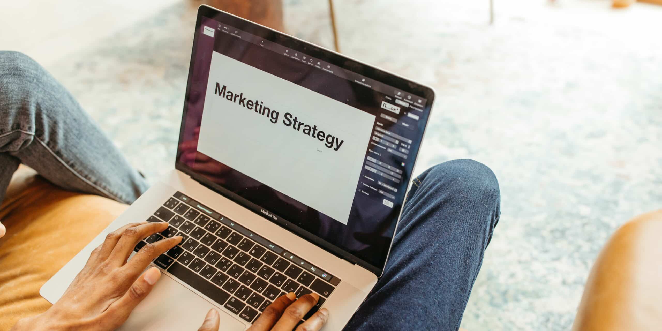 Person with laptop writing a marketing strategy