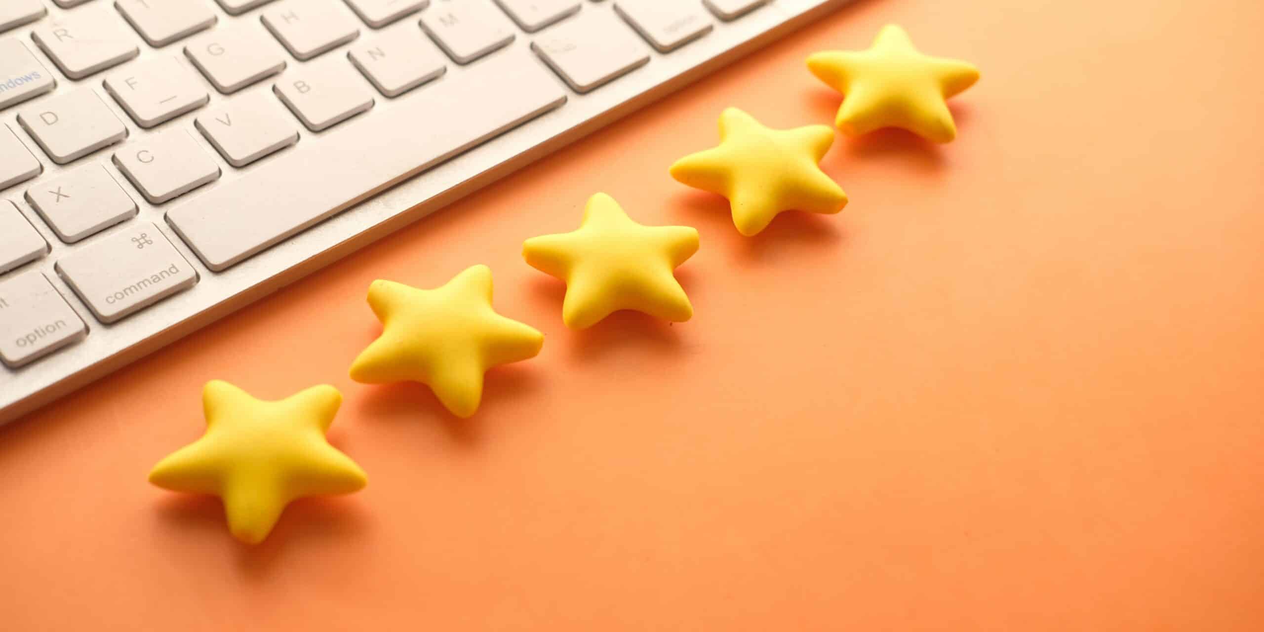 5 stars next to keyboard on orange background